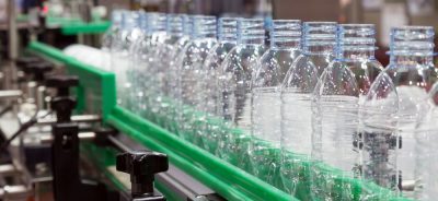 plastic bottle on factory line machine in the factory, bottle industry, bottle factory, bottle machine, plastic bottle in fatory line. selective focus